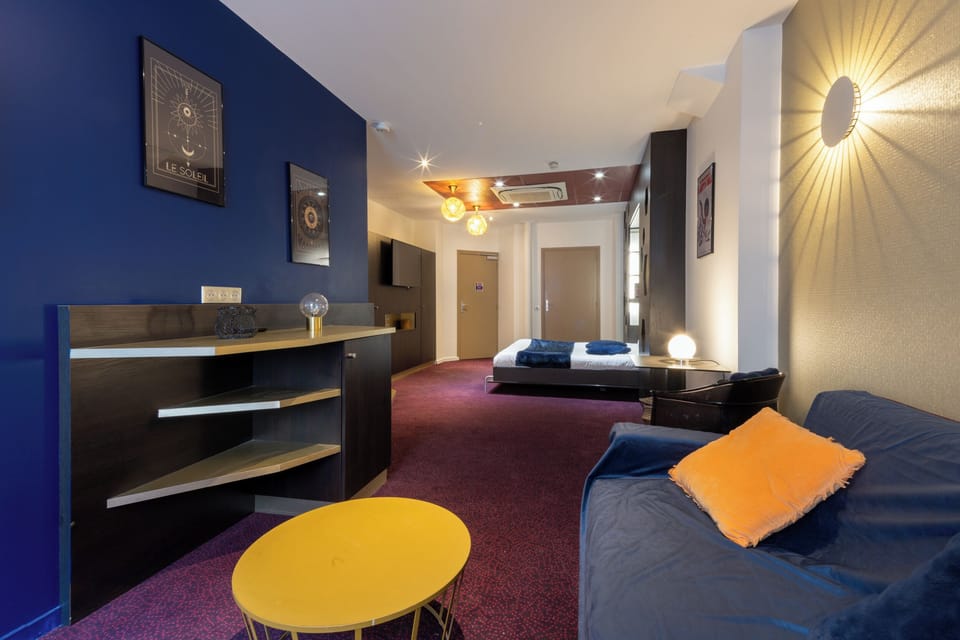 Deluxe Quadruple Room | Living area | 26-inch LCD TV with satellite channels, TV