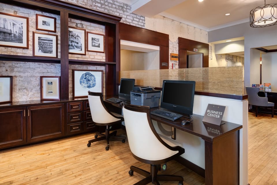 A fully equipped business center with computers, monitors, and workstations.