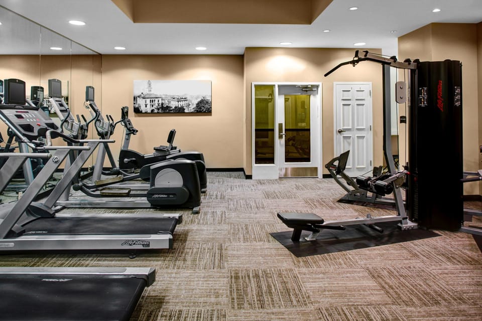 Well-equipped fitness center with cardio machines and strength training equipment.