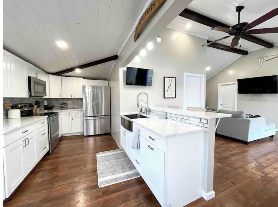 New open concept kitchen featuring French door refrigerator, microwave, stove