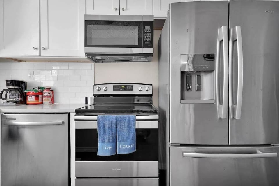 Fully Stocked Kitchen
- Full-size French door refrigerator w/ ice maker
- Electric stove
- Dishwasher
- Microwave
- Plates, bowls, & cups
- Silverware
- Coffee maker
