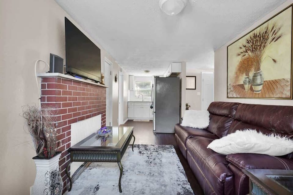 Living Room with 50" Smart HDTV and reclining sofa.