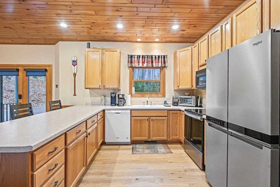 Spacious kitchen with stove, fridge, dishwasher, microwave, and all the cooking essentials such as pots, pans, and utensils.  (Due to health dept guidelines we are not allowed to leave and food/seasonings for guests use)