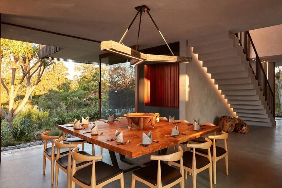 Dining area with recessed ceiling lights, a wooden dining table that seats 12