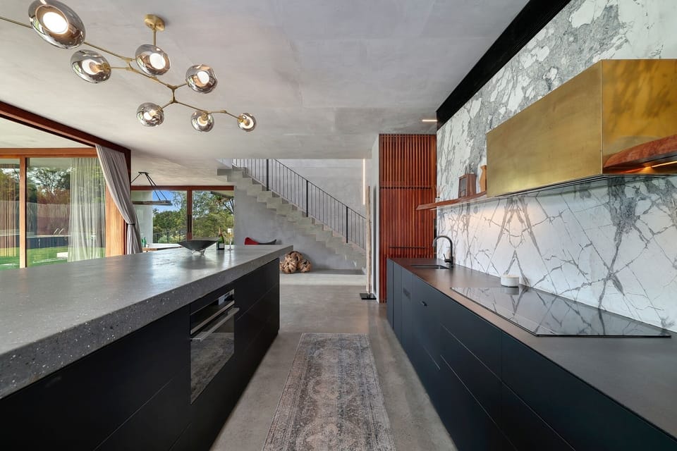 Gourmet kitchen with butlers kitchen, recessed lighting, counter with sink.