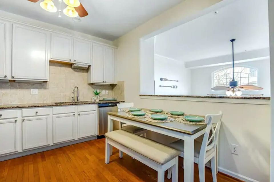 Kitchen is stocked with glassware, utensils, and plates/bowls.