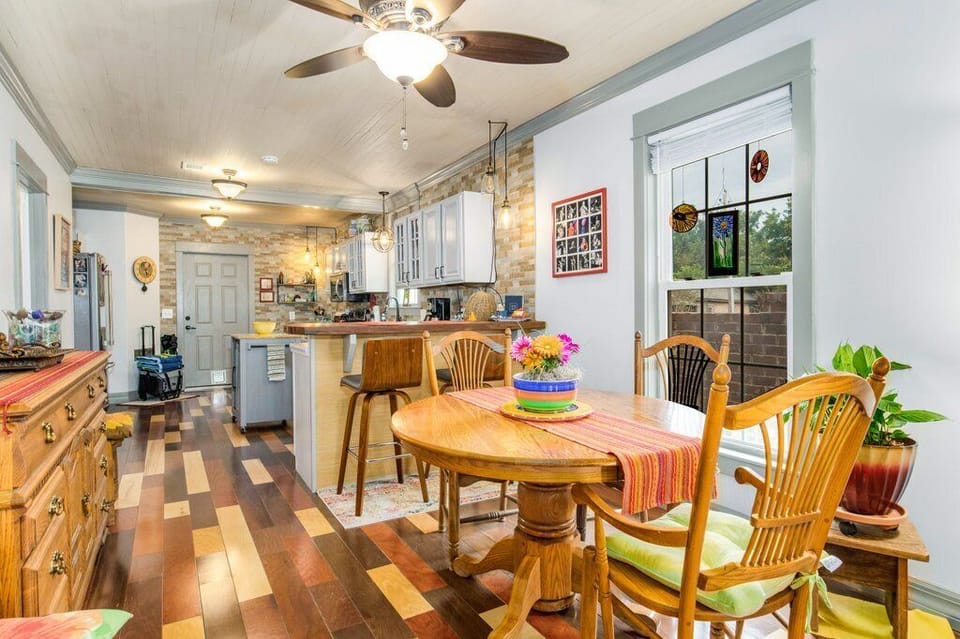 Bright dining space at the Boho Bungalow invites couples or small adult families to share slow mornings over coffee in this historic downtown Pensacola neighborhood.