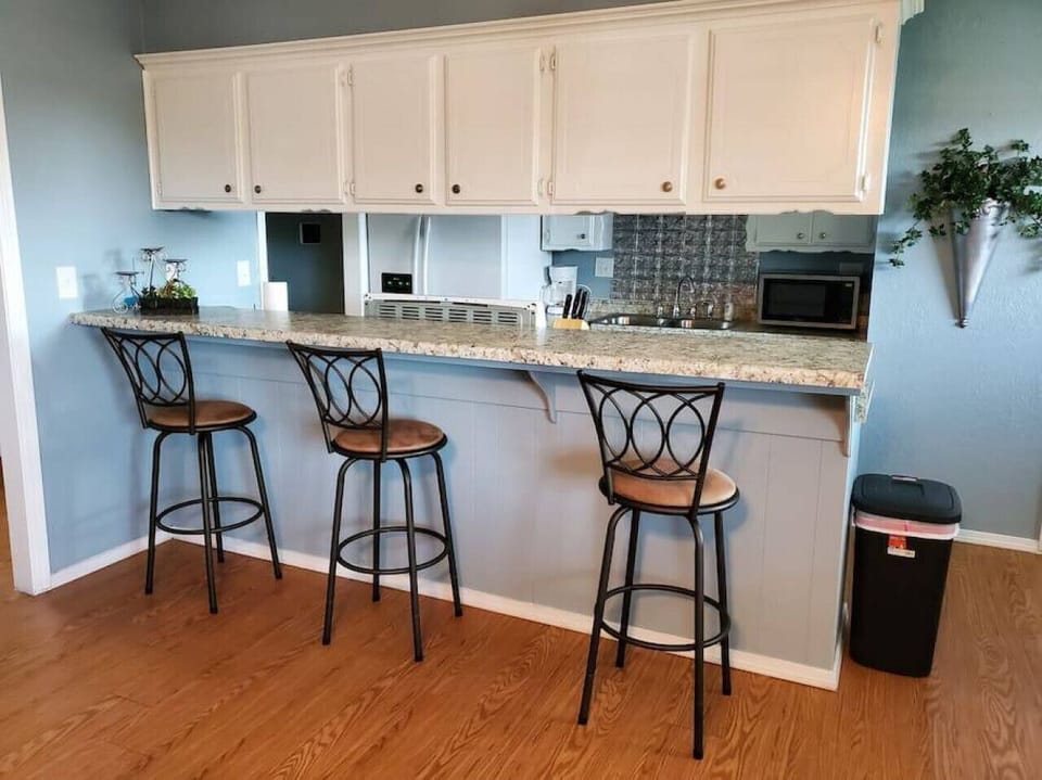 Enjoy a cozy meal or chat over drinks at the inviting countertop with comfortable chairs.