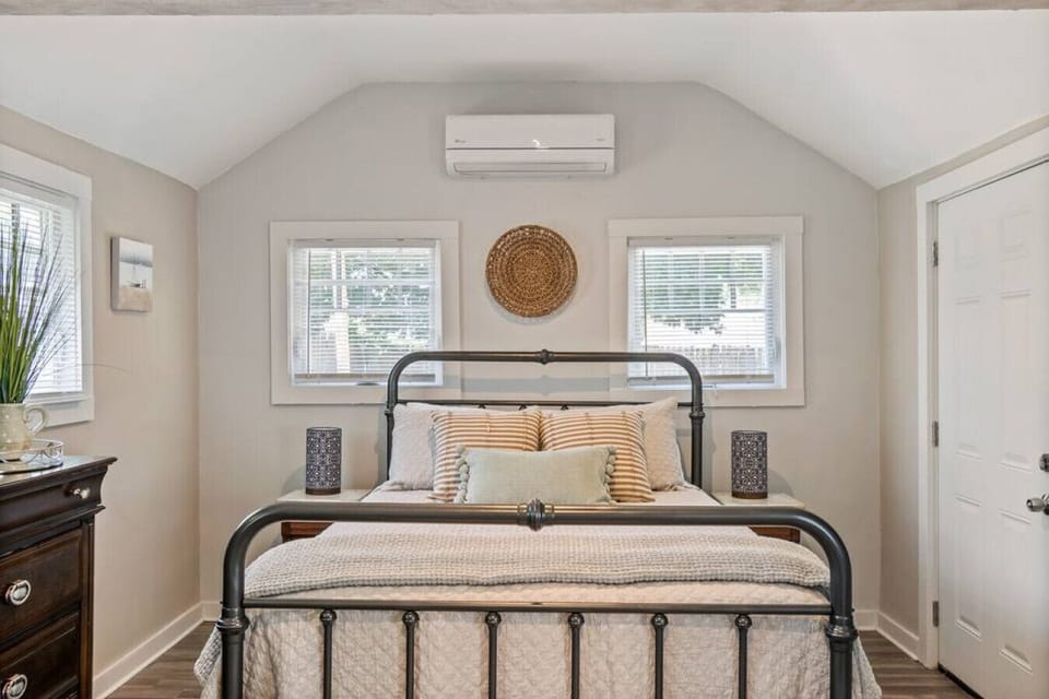 Neutral-toned queen bedroom for restful sleep.