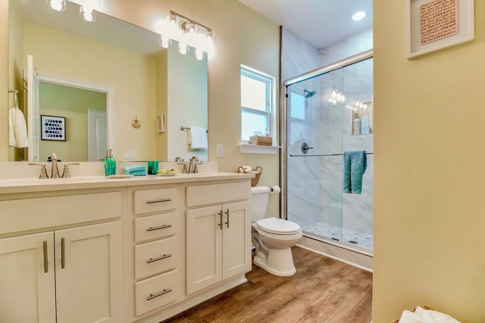 Bright modern bath with large vanity and glass walk-in shower