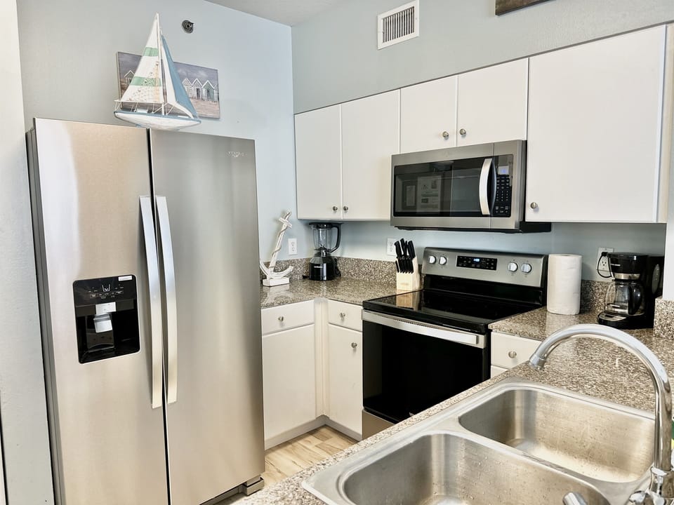 Fully equipped kitchen with granite counters and stainless appliances for easy vacation cooking.
