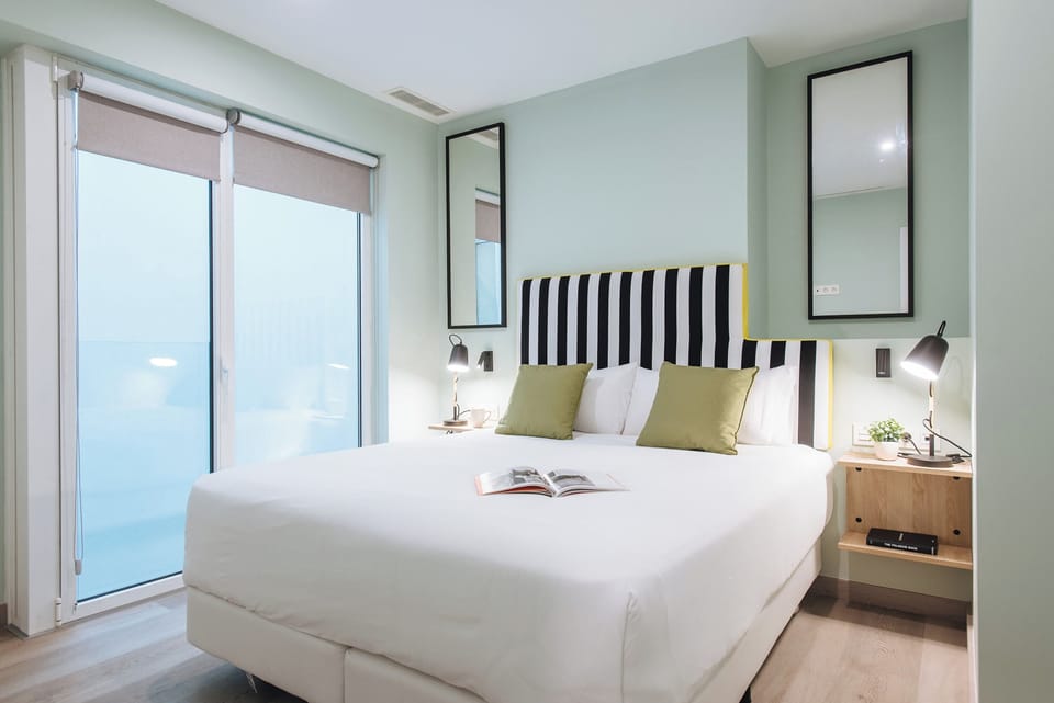 Desk, laptop workspace, bed sheets
