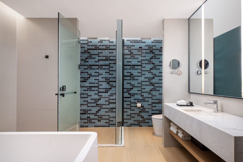 Premium Suite, 1 Bedroom | Bathroom | Hydromassage showerhead, designer toiletries, hair dryer, bathrobes