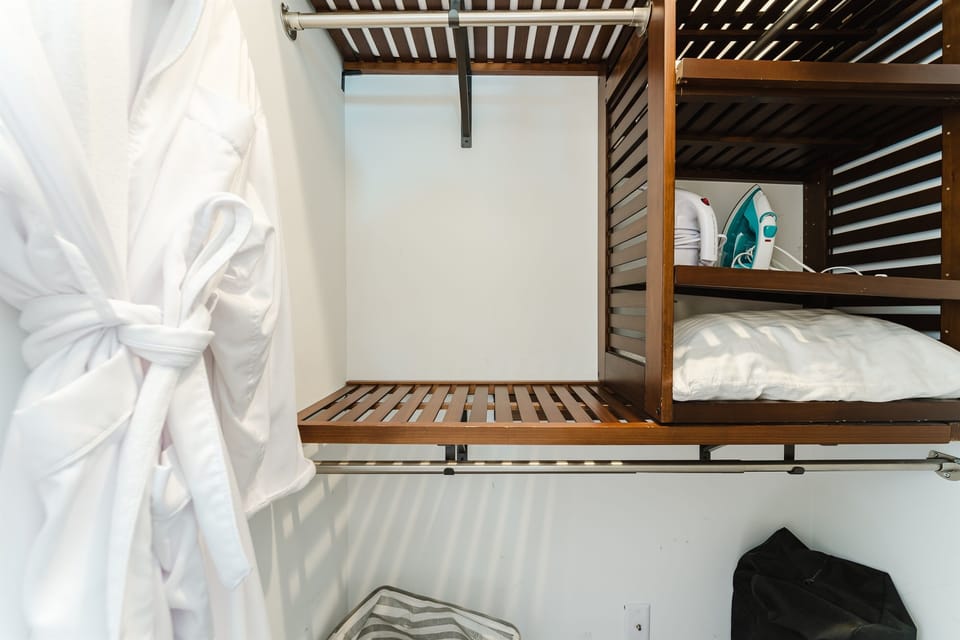 Thoughtfully stocked for a seamless stay, the spacious walk-in closet includes plush robes, luggage racks, an iron and steamer, extra storage, and plenty of hanging space—making it easy to settle in and feel at home from the moment you arrive.