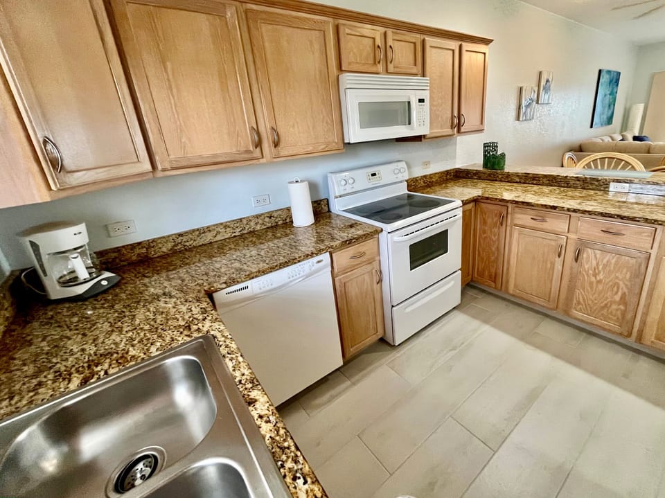 Kitchen has fridge freezer, oven, cook top, microwave and dishwasher.