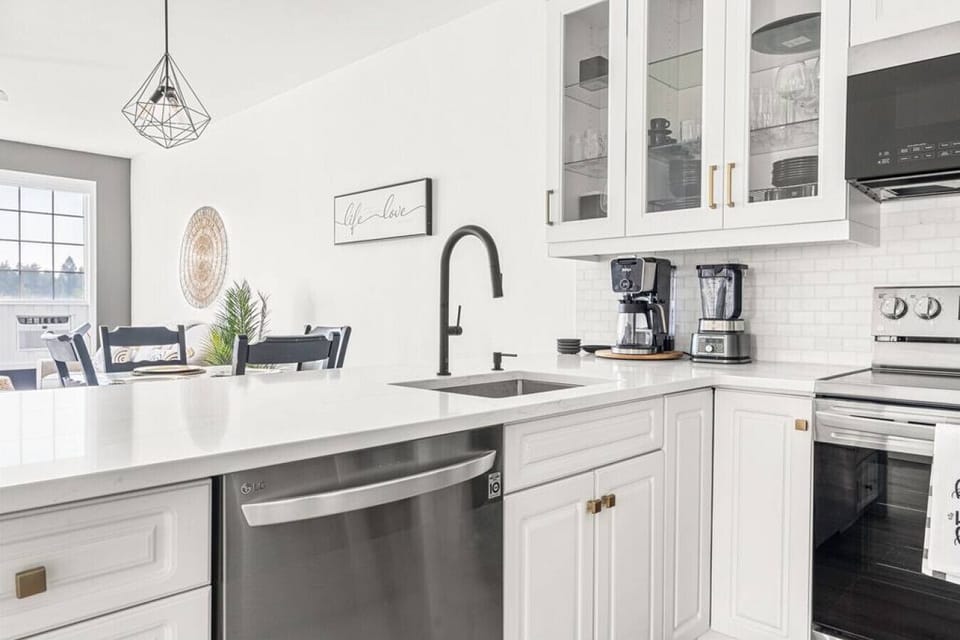 Full kitchen with a drip coffee maker, ground coffee, tea and sugar.