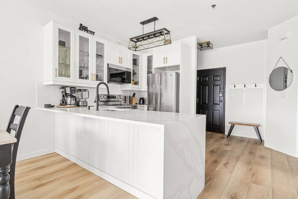 Full kitchen with a drip coffee maker, ground coffee, tea and sugar.