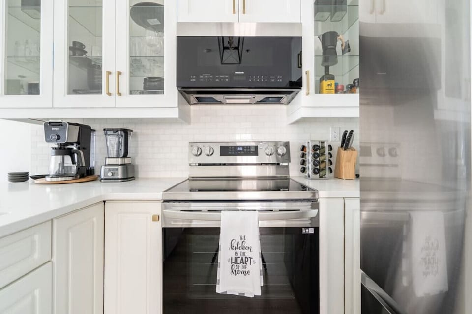Full kitchen with a drip coffee maker, ground coffee, tea and sugar.