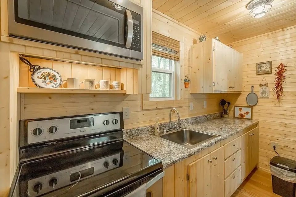 Cabin style tiny home with fire pit, outdoor seating, hammock, & full kitchen