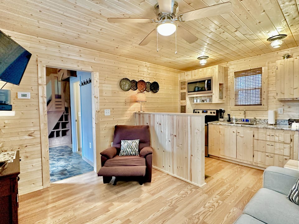Cabin style tiny home with fire pit, outdoor seating, hammock, & full kitchen