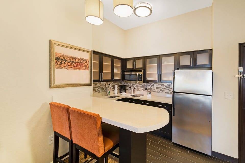 Gather around the chic kitchen bar, perfect for casual meals and morning coffee.