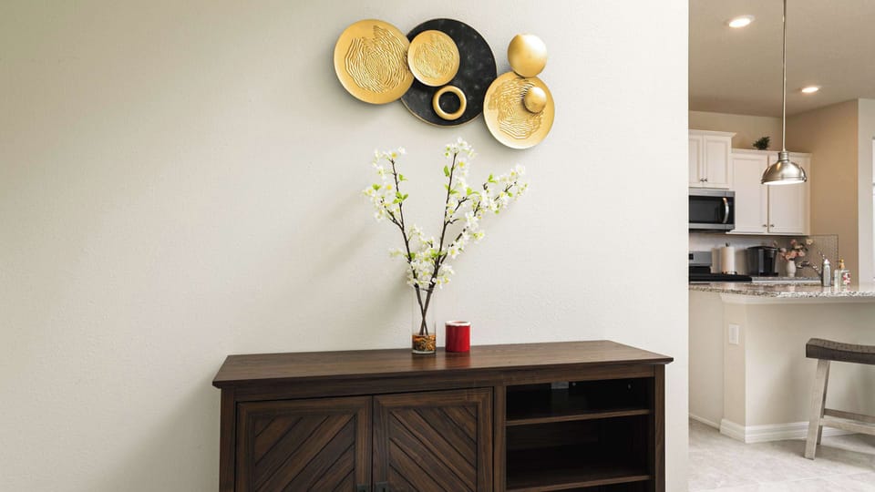 Artful gold accents and fresh florals define this sophisticated, light-filled living space.