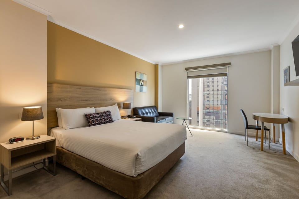 Executive Queen Room (Spencer Street View) | In-room safe, desk, laptop workspace, blackout drapes