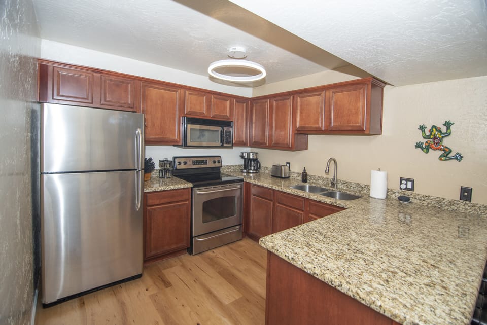 The well equipped kitchen has a dishwasher, fridge/freezer, stove & ice maker.