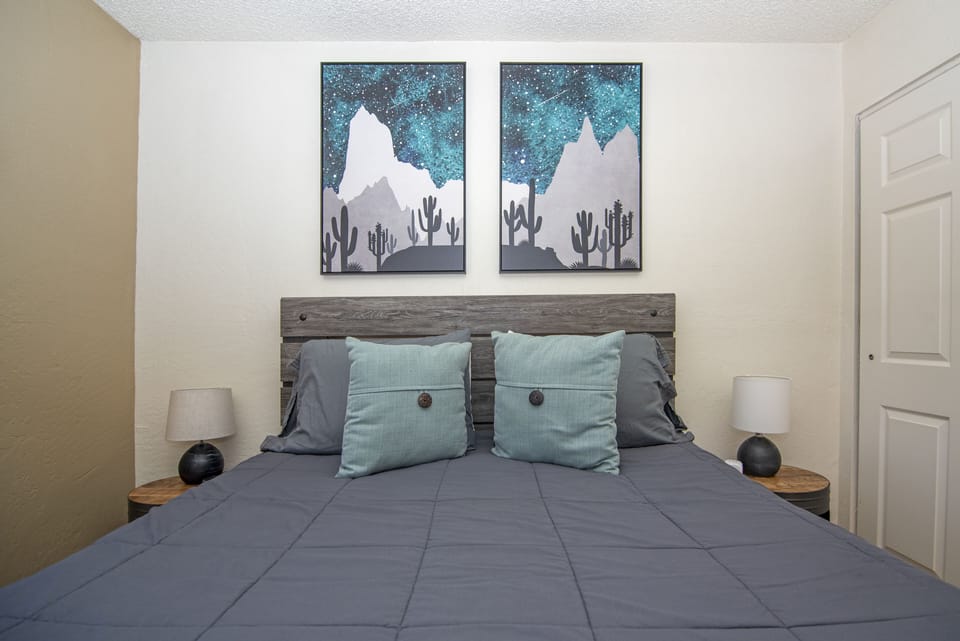 The bedroom has a dresser, TV, ample closet space and two nightstands.