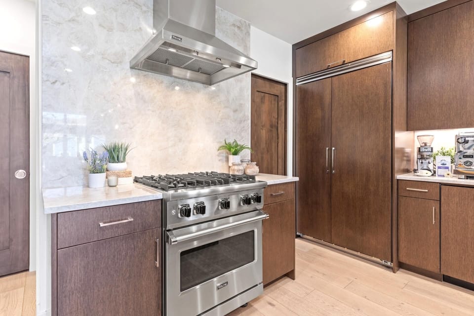 Cook like a pro with a six-burner gas range, spacious counters, and open sightlines.