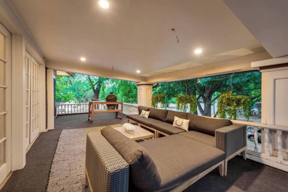 A stylish terrace featuring outdoor living room seating and a Big Green Egg Grill, offering the perfect setting for entertaining in comfort and style.