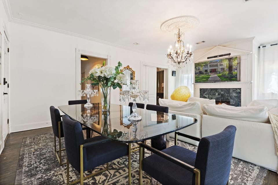 The dining area is gracefully positioned adjacent to the cocktail lounge, featuring a wine refrigerator and a fully equipped wet bar, perfect for entertaining with style and convenience.