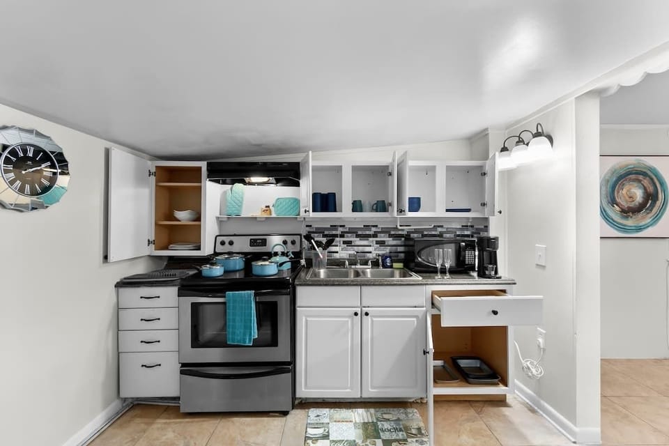 Kitchen comes fully stocked with:
- Microwave & Oven
- Full Size Fridge
- K-Cup Coffee with K Cups 
    - Breakfast, Normal, & Decaf
- Home Hero knife set
- Pots, Pans and a kettle
- Silverware
- 4 sets of plates, bowls, & cups
- 2 wine glasses
