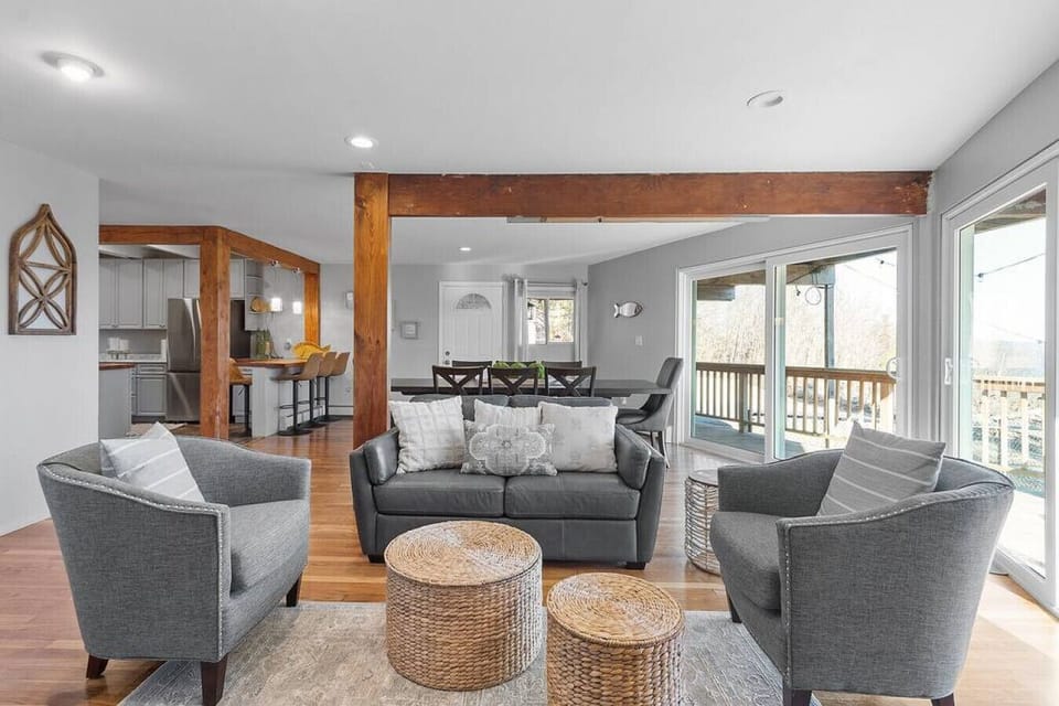 First floor living room with magnificent lake views and access to the back yard from the deck. Open floor concept.