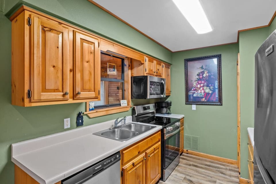The kitchen area includes a full suite of new stainless steel appliances as well as a Keurig Duo coffee maker.