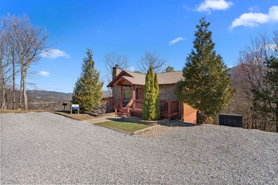 The entrance to the cabin. The parking area provides space for up to 3 vehicles and the charcoal BBQ Grill is located in the front yard.