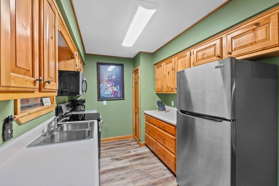 The kitchen is conveniently located just off the living room with the dining table that seats 4 guests.
