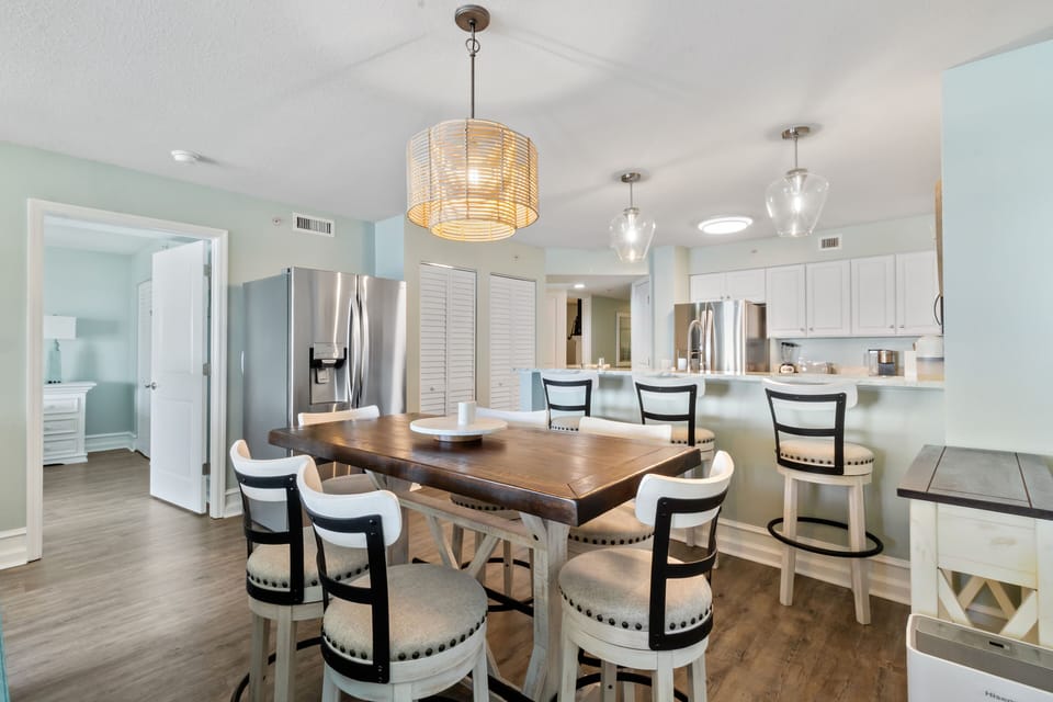 Your spacious dining area flows seamlessly into the modern kitchen, perfect for hosting memorable meals with stunning pendant lighting overhead.