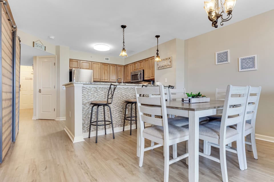 Your open kitchen flows seamlessly into the dining area, perfect for preparing meals and sharing stories around the spacious table.