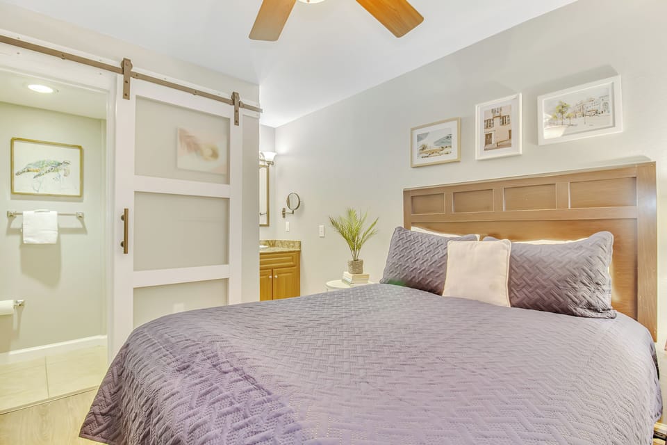 Your stylish bedroom features warm wood accents and soft lavender linens, creating the perfect retreat for restful nights.