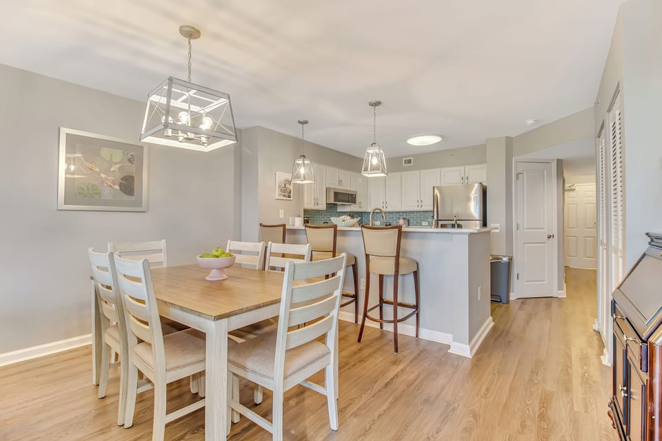 Gather around this bright dining table where your morning coffee tastes better and evening conversations flow naturally into the open kitchen.