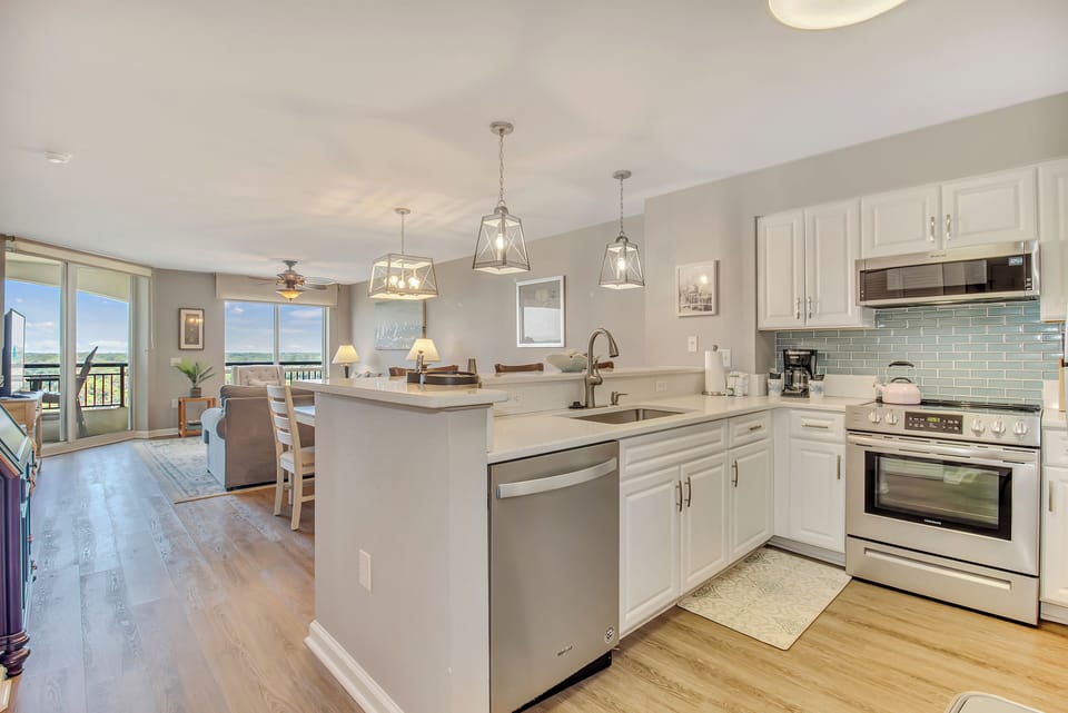 Your open-concept kitchen features gleaming white cabinets, stainless steel appliances, and a spacious island perfect for cooking memorable meals together.