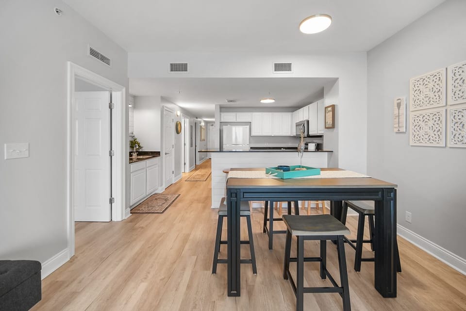 Your bright, open kitchen flows seamlessly into the dining area with warm wood floors and modern finishes throughout.
