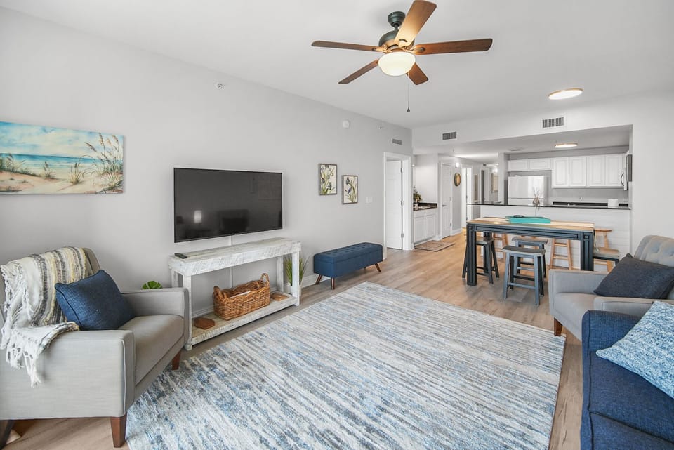 Unwind in your bright, coastal-themed living space with plush seating, smart TV, and open kitchen perfect for memorable meals together.
