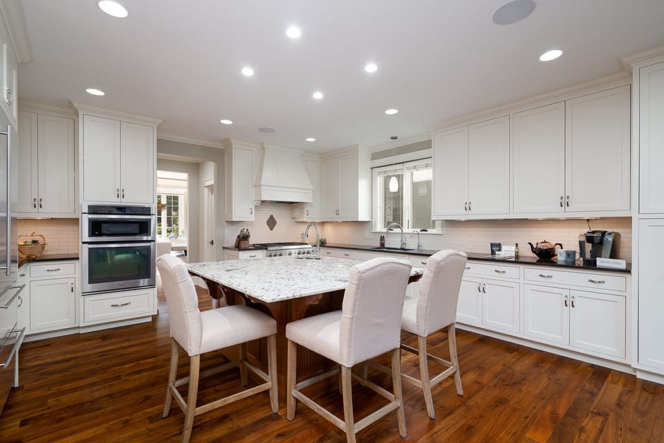 Your gourmet kitchen awaits with marble island seating, premium appliances, and abundant counter space for memorable meal preparation.