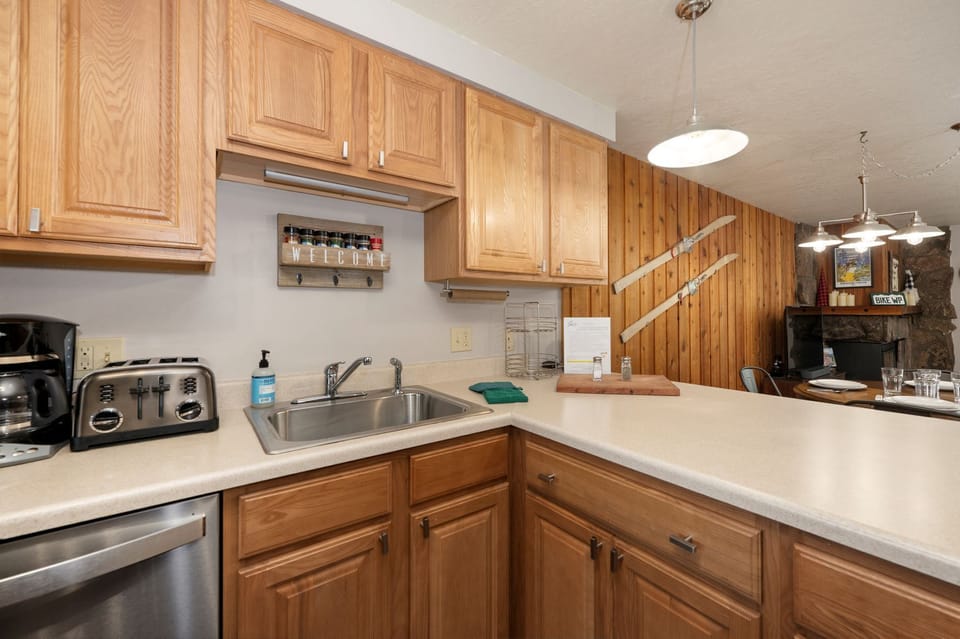 Your fully equipped kitchen features warm wood cabinets, ample counter space, and modern appliances for preparing memorable meals during your stay.