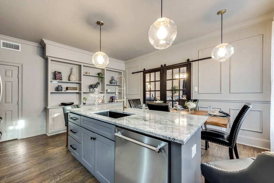 The fully equipped kitchen features a spacious island, plenty of counter space, and stunning marble countertops. With abundant natural light, it's the perfect space for preparing a gourmet meal or entertaining guests.