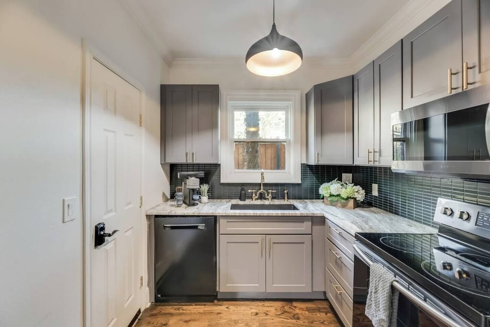 The fully equipped kitchen, complete with modern amenities, offers a convenient side entrance, making it both functional and easy to access.