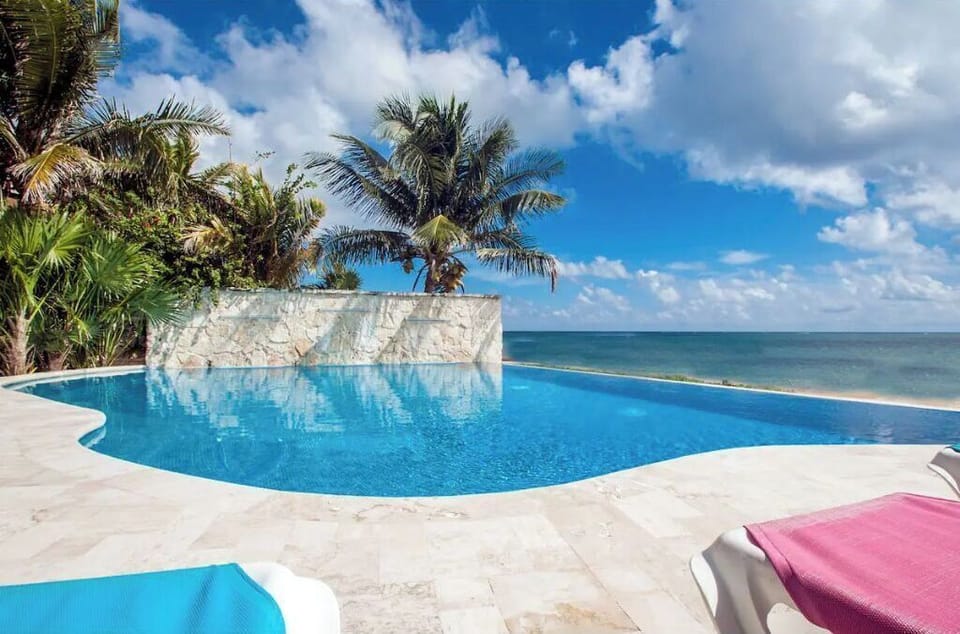 The enormous, stunning infinity pool looks out over the beach and ocean.
