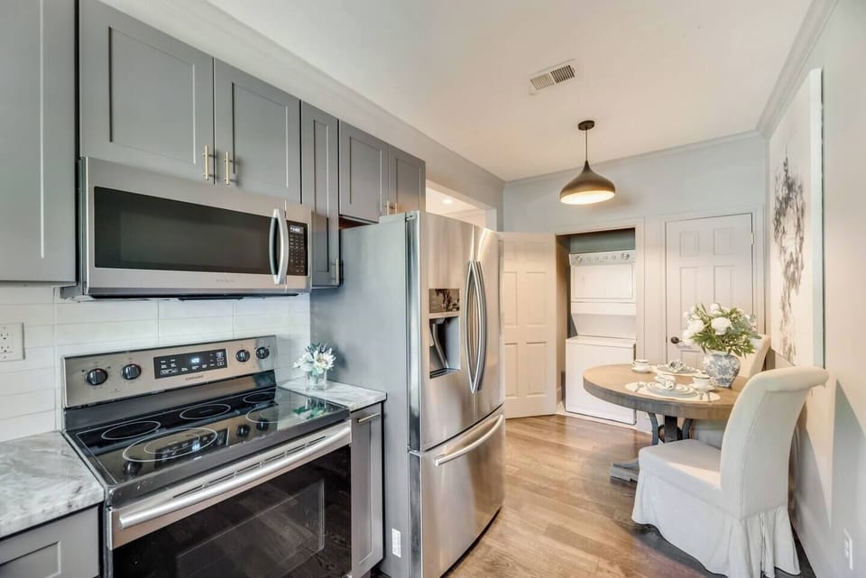 The fully equipped kitchen, complete with modern amenities, offers a stackable washer/dryer in unit  making it both functional and easy to access.